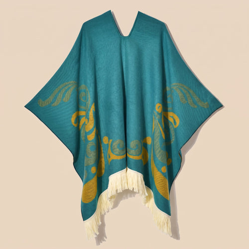 Cape poncho femme ouverte motif turquoise, présentée à plat de face. Le décolleté en V et les motifs dorés sur le devant