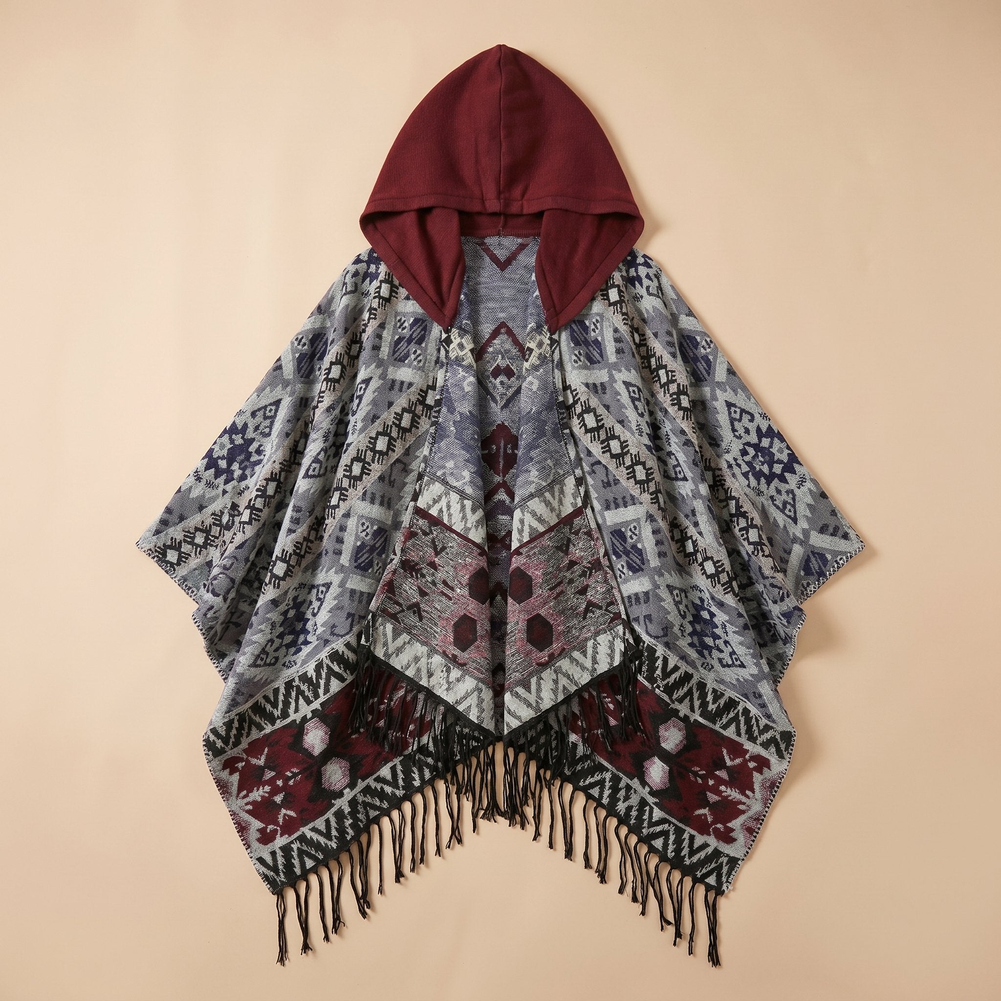 Poncho à capuche homme à motif et franges, coloris gris, bordeaux et noir, présenté à plat de face avec sa capuche bordeaux