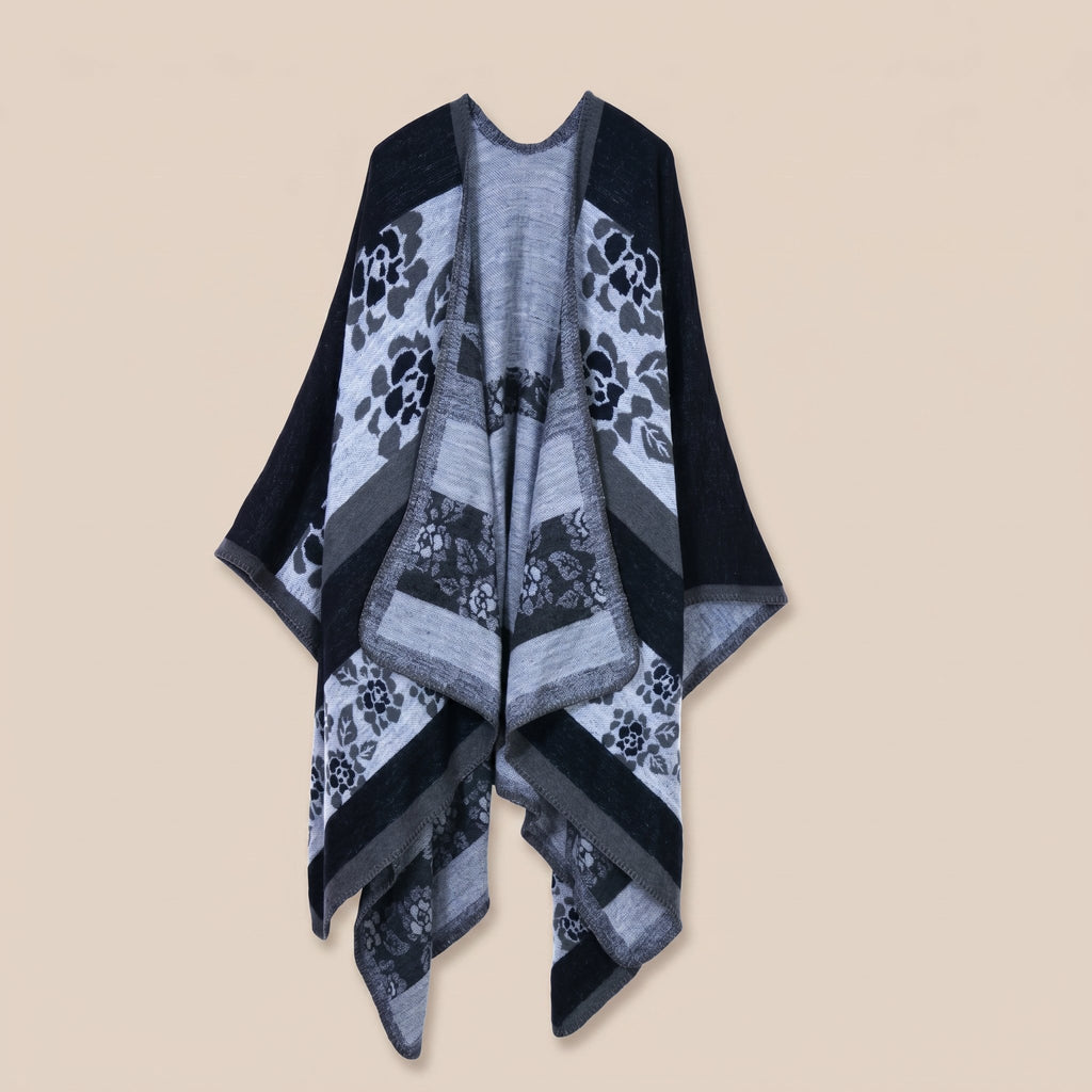 Poncho cape femme motif floral noir et gris, présenté à plat sur un fond uni.
