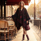 Poncho cape femme à motif géométrique et franges noir et rouge, porté par une femme debout en extérieur, de face
