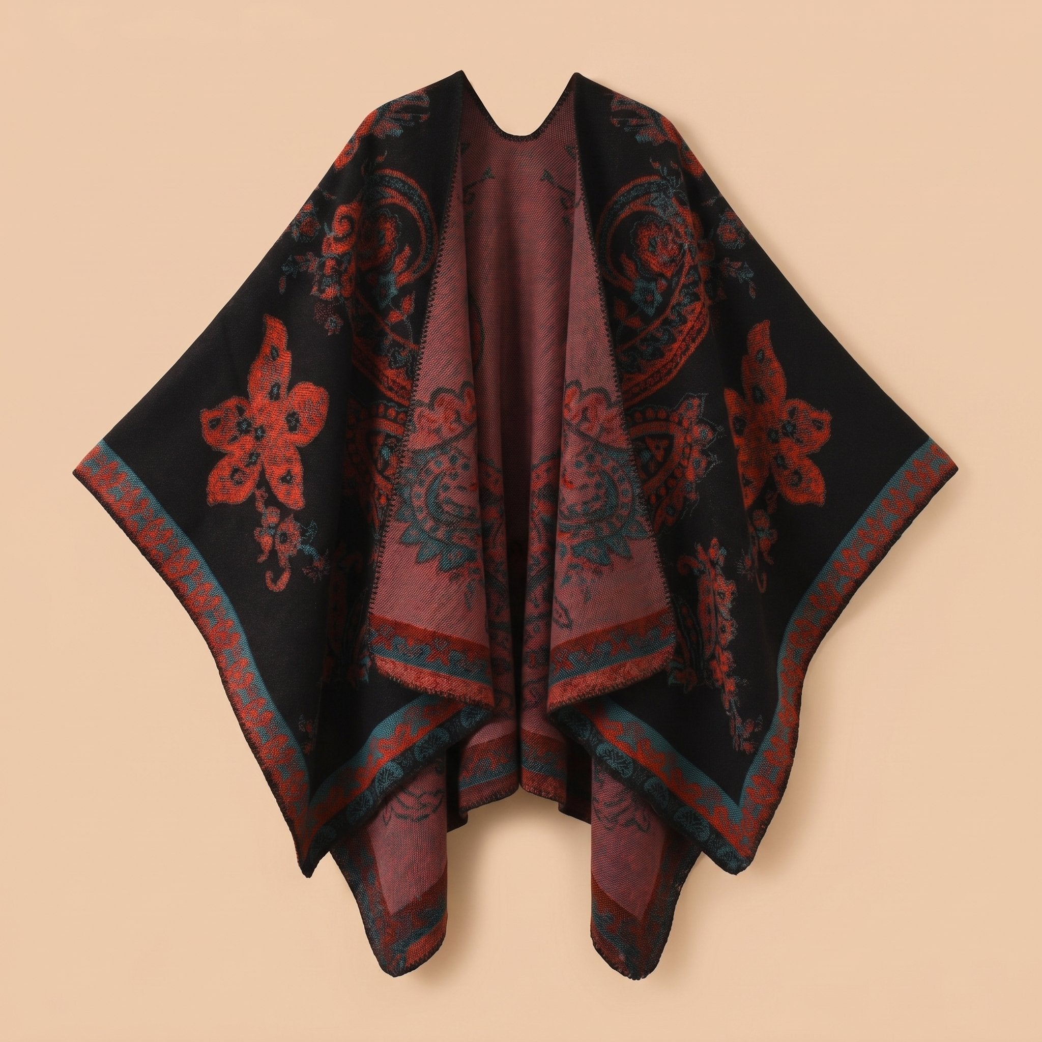 Poncho cape femme motif Paisley noir et rouge, présenté à plat, avec des bordures colorées visibles.