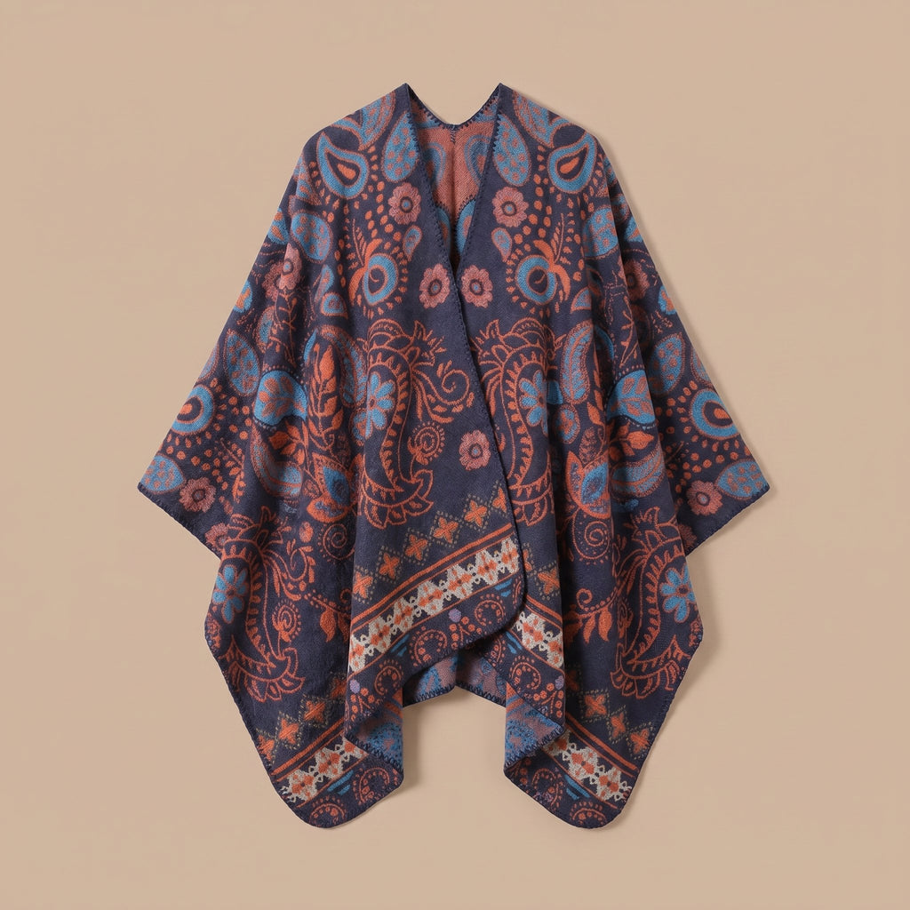 Poncho cape homme paisley bleu présenté à plat sur un fond neutre, montrant la coupe ample et le motif détaillé du tissu