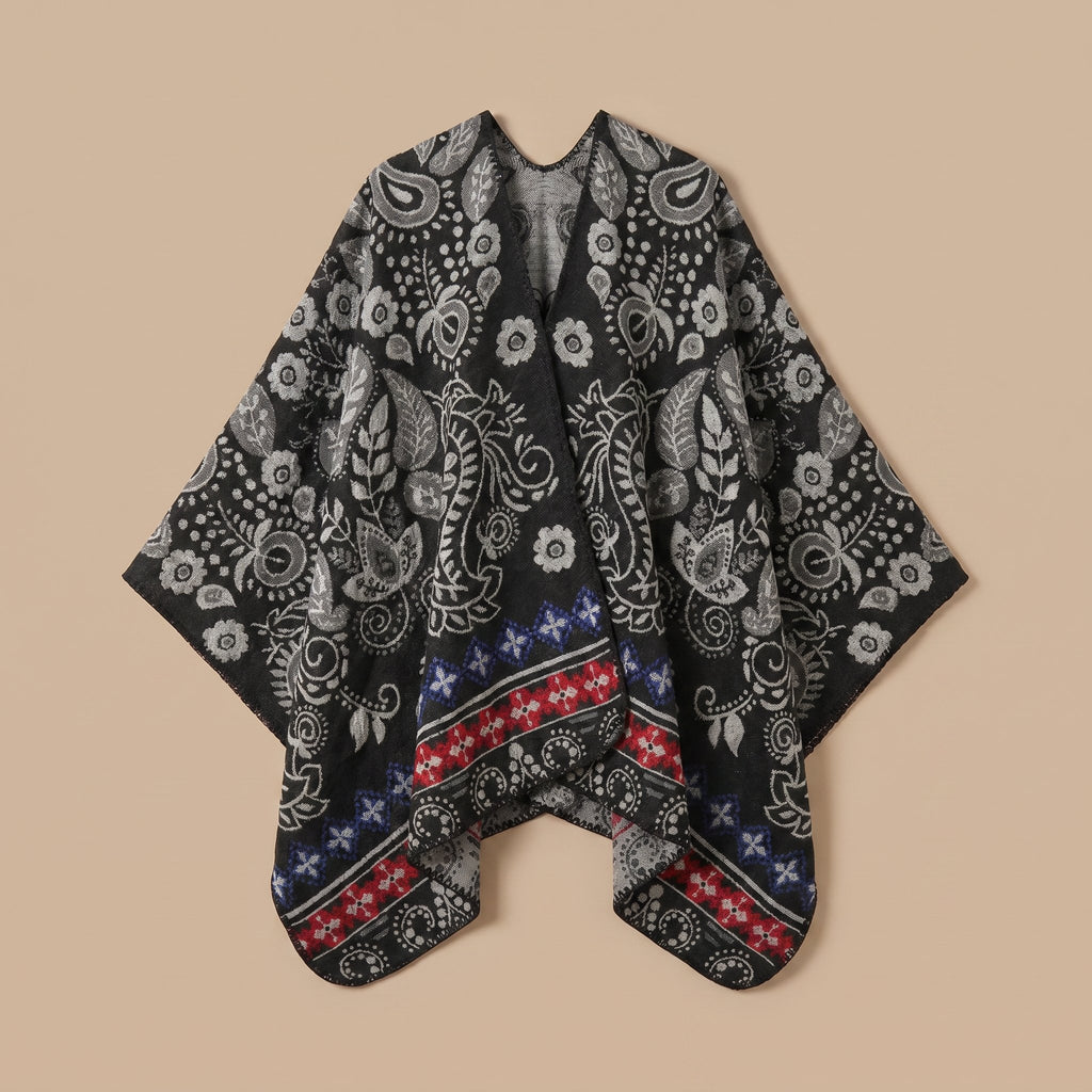 Poncho cape homme paisley noir présenté à plat sur un fond uni
