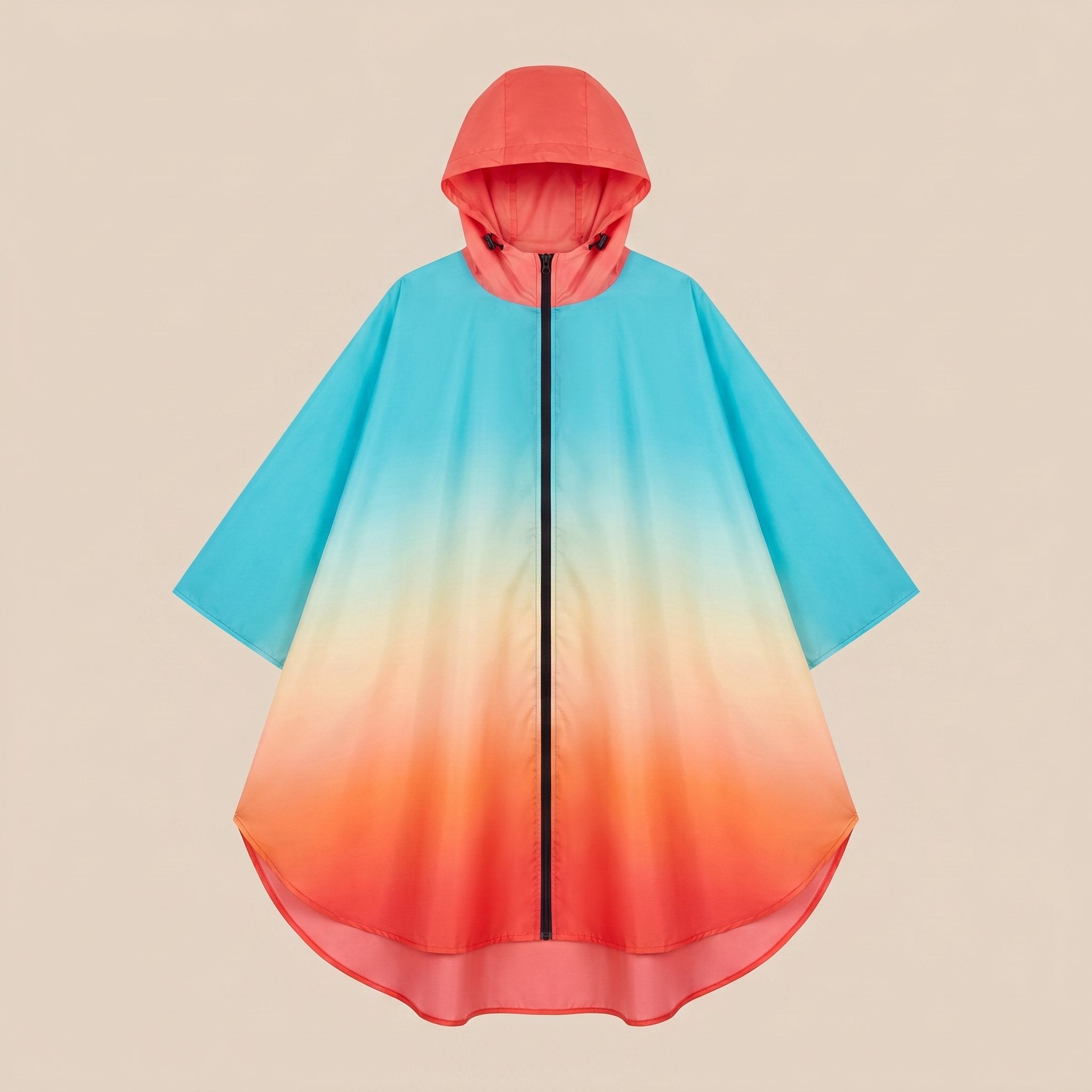 Poncho de pluie à capuche dégradé ciel et corail, présenté à plat sur un fond uni, vu de face.