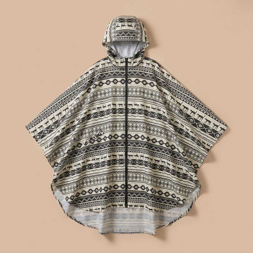 Poncho de pluie à capuche motif ethnique noir et blanc, présenté à plat sur un fond uni.
