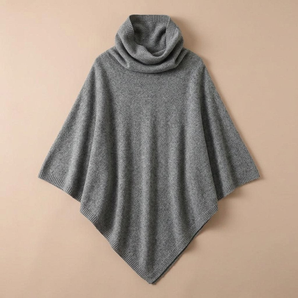 Poncho en laine femme col roulé gris moyen, posé à plat sur un fond clair.