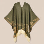 Poncho femme ethnique olive à franges, présenté à plat sur un fond uni, montrant son motif beige et ses franges claires