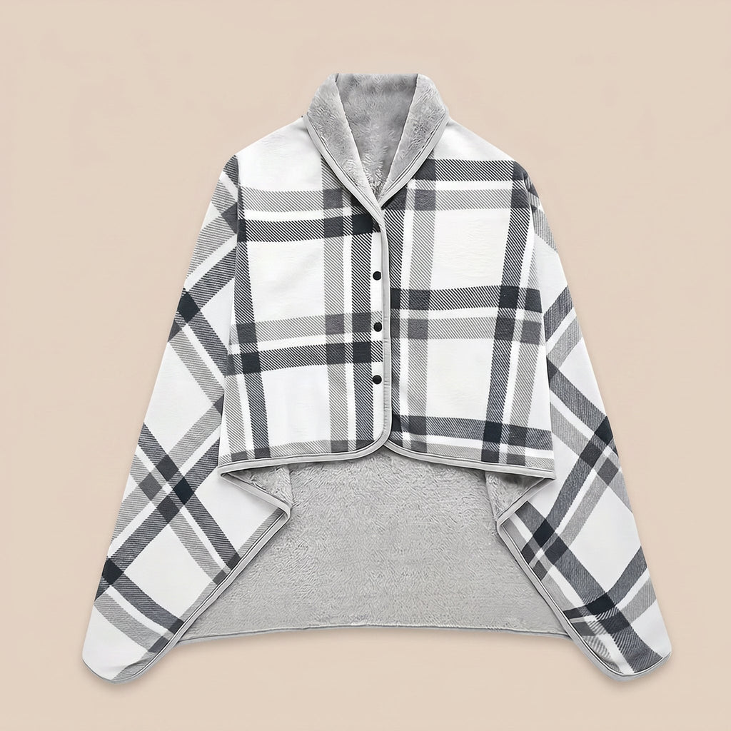 Poncho plaid à carreaux blancs présenté à plat sur un fond uni clair, montrant son motif et sa doublure.