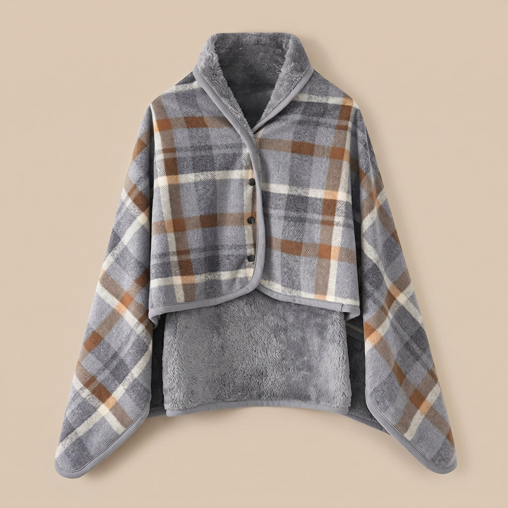 Poncho plaid à carreaux gris et brun présenté à plat, montrant le motif et la doublure douce.