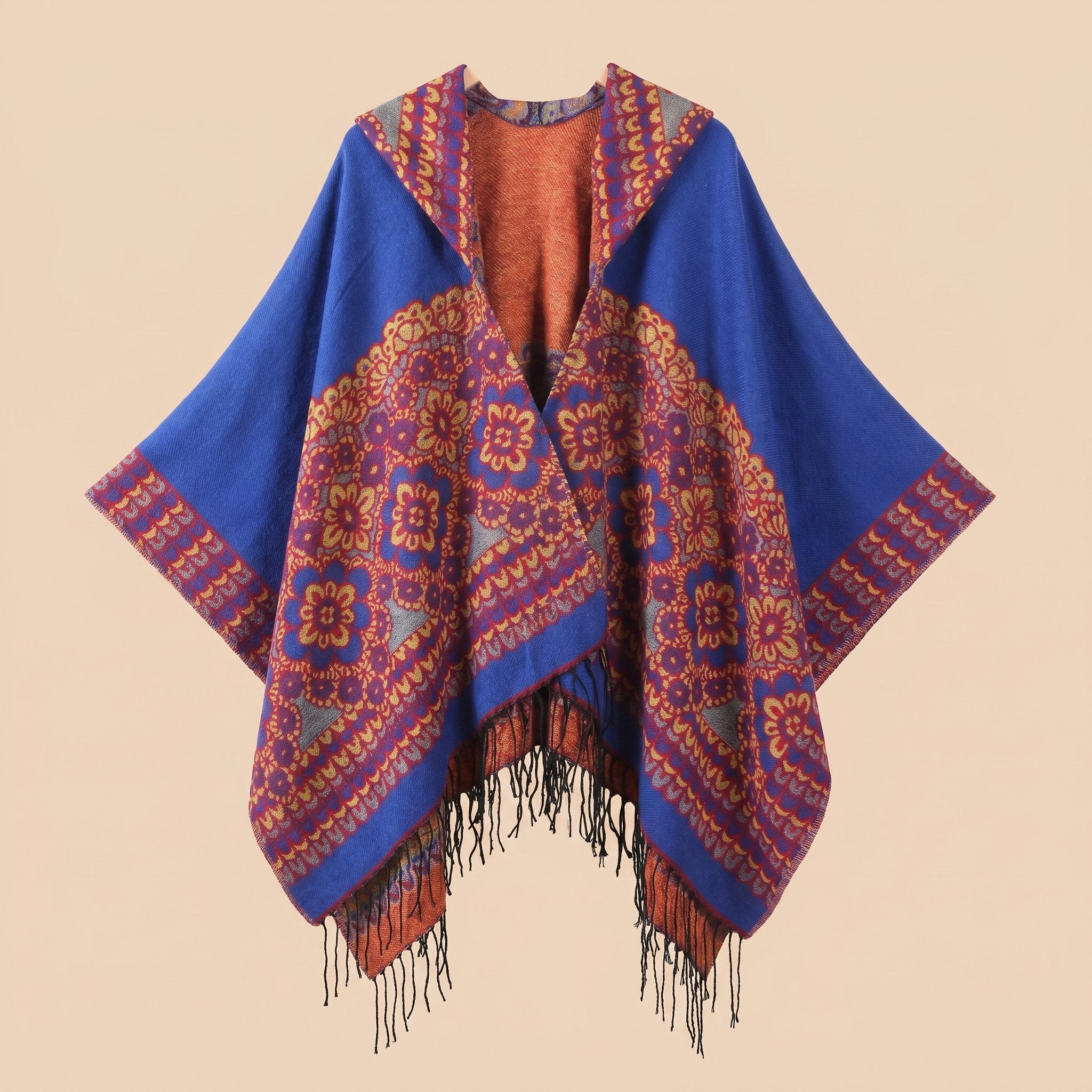 Poncho plaid à capuche motif floral, présenté de face avec des motifs ronds et des franges.