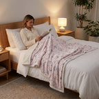 Poncho plaid koalas et fleurs, porté par une femme assise, une tasse à la main.