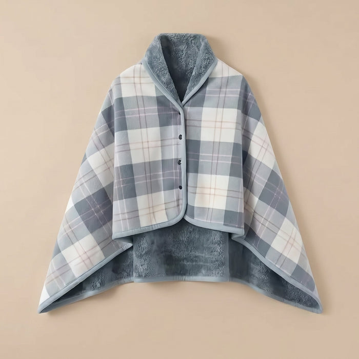 Poncho polaire à carreaux gris et blanc présenté à plat, révélant son intérieur doux et réversible.