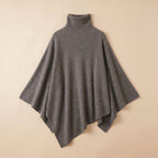 Poncho pull femme gris moyen, col roulé, photographié à plat.