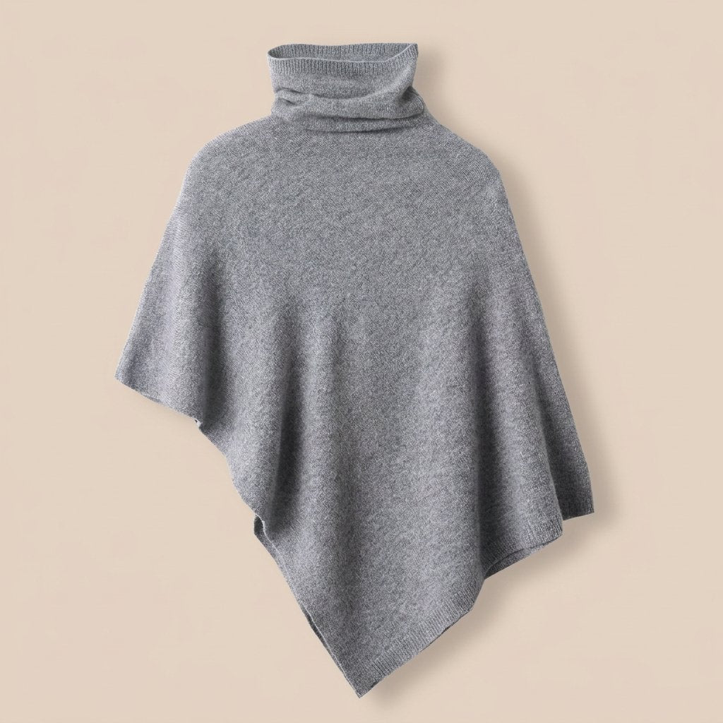 Poncho pull femme col roulé gris, avec un col roulé ample et une forme fluide.