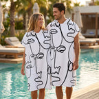 Poncho serviette à capuche adulte Visages au trait porté au bord de la piscine